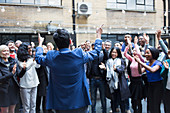 Business people cheering for businessman