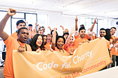 Hackers cheering with banner, coding at hackathon
