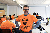 Portrait hacker coding for charity at hackathon