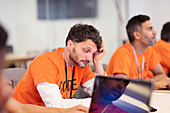 Focused hacker coding for charity at hackathon