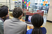 Business people video conferencing at laptop