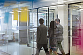 Business people walking and talking corridor