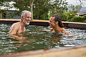 Father and son relaxing in hot tub