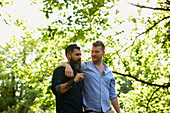 Affectionate male gay couple walking