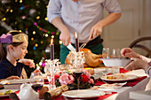 Father carving Christmas turkey