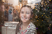 Portrait happy girl at wet window