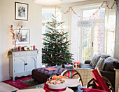 Festive, decorated Christmas tree and living room