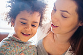 Mother and daughter looking down