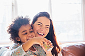 Laughing, carefree mother and daughter