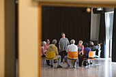 Woman leading seniors in group discussion