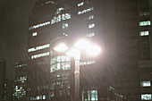 Rain falling around streetlamp at night