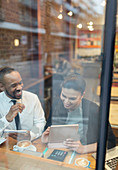 Business people working at cafe window