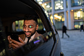 Businessman in crowdsourced taxi at night