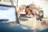 Teacher and students using laptop