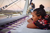 Serene young woman relaxing on catamaran