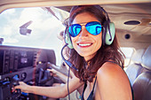 Portrait young woman flying airplane