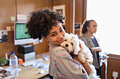 Portrait creative businesswoman with cute dog