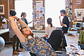 Creative designer stretching in office