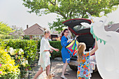 Lesbian couple and daughter loading car