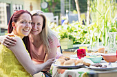 Lesbian couple enjoying lunch on patio