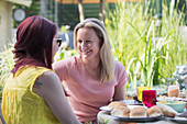 Lesbian couple enjoying lunch on patio