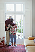 Serene senior couple looking out window