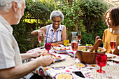 Senior friends enjoying lunch at patio table