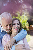 Affectionate, smiling senior couple hugging