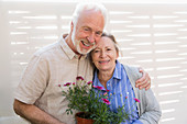 Portrait Senior couple with flowerpots