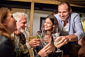 Friends toasting cocktails on patio