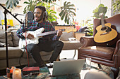 Musician recording music in apartment