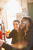 Happy young couple enjoying cocktails