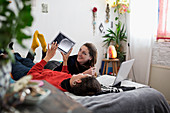 Young women friends relaxing on bed