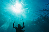Woman scuba diving underwater