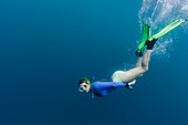 Portrait young woman snorkelling underwater