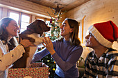 Family playing with dog in Christmas gift box