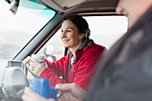 Woman drinking coffee and driving motor home