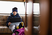Teenage boy using digital tablet in motor home