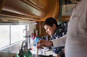Father and soon cooking in motor home