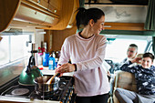 Mother cooking for family in motor home