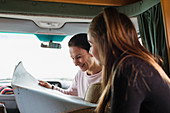 Mother and daughter looking at map in motor home