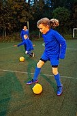 Girl soccer player practicing