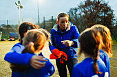 Girls soccer team listening to coach