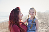 Portrait mother and daughter on beach