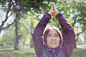 Active senior woman exercising, practicing yoga