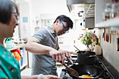 Couple cooking at kitchen stove