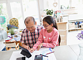 Grandfather and granddaughter using tablet