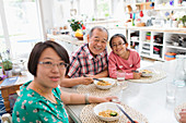 Portrait Family eating noodles with chopsticks