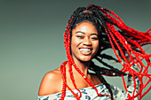 Portrait carefree young woman with red braids