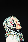 Portrait woman in floral hijab looking up